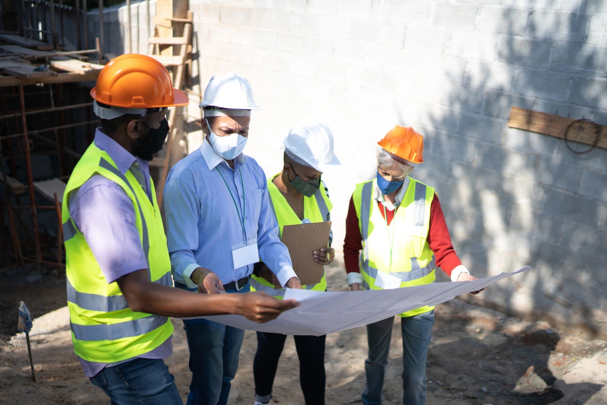 Construction workers reviewing building plans