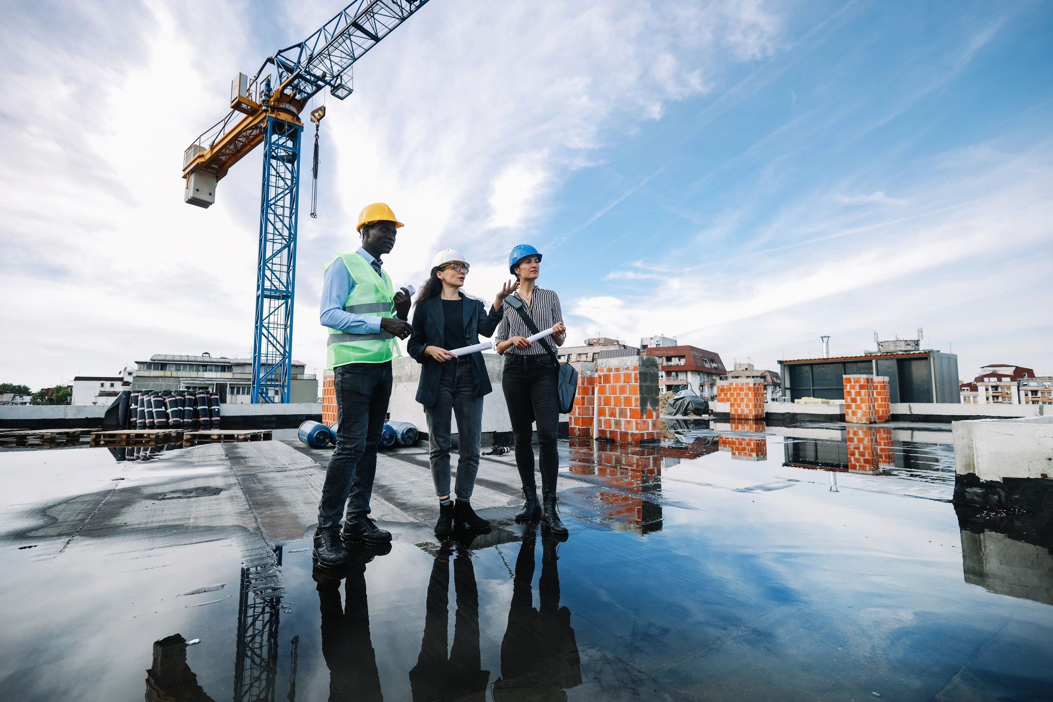 Project stakeholders reviewing plans at a construction site