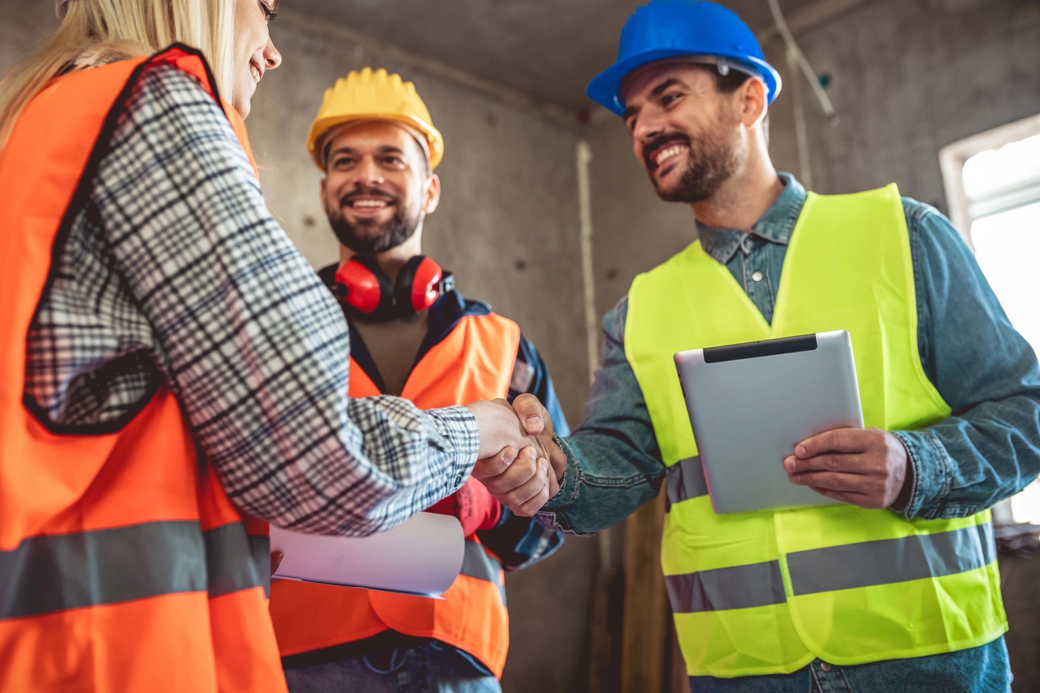 Construction professionals shaking hands at a job site