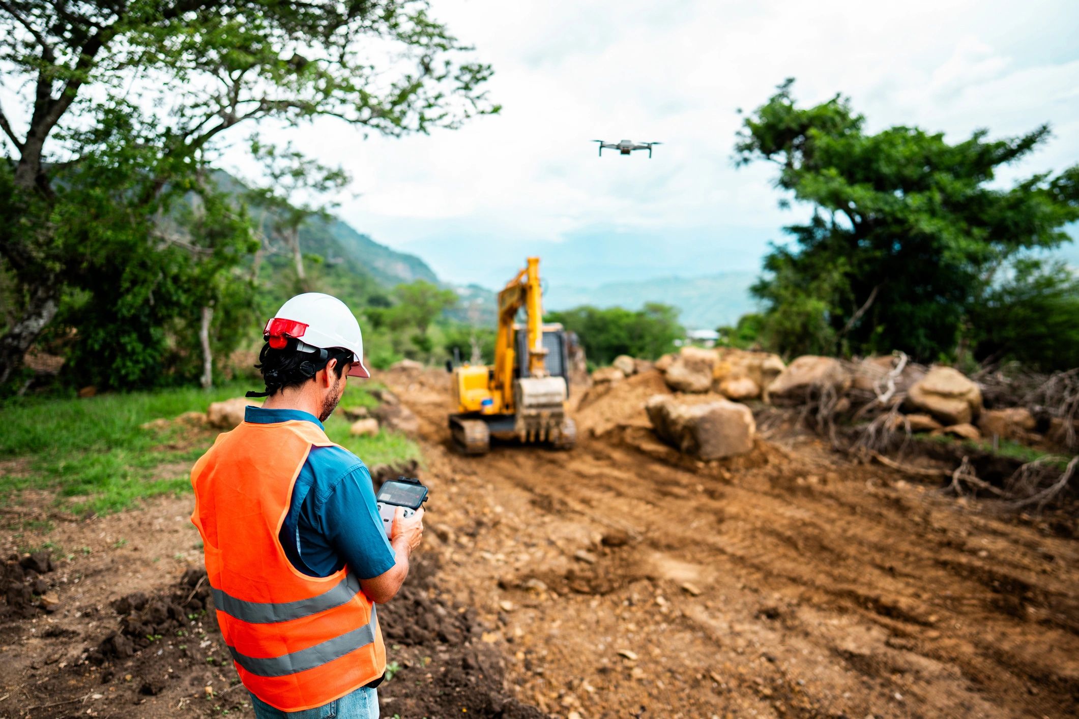 Project manager operating a drone at a construction site