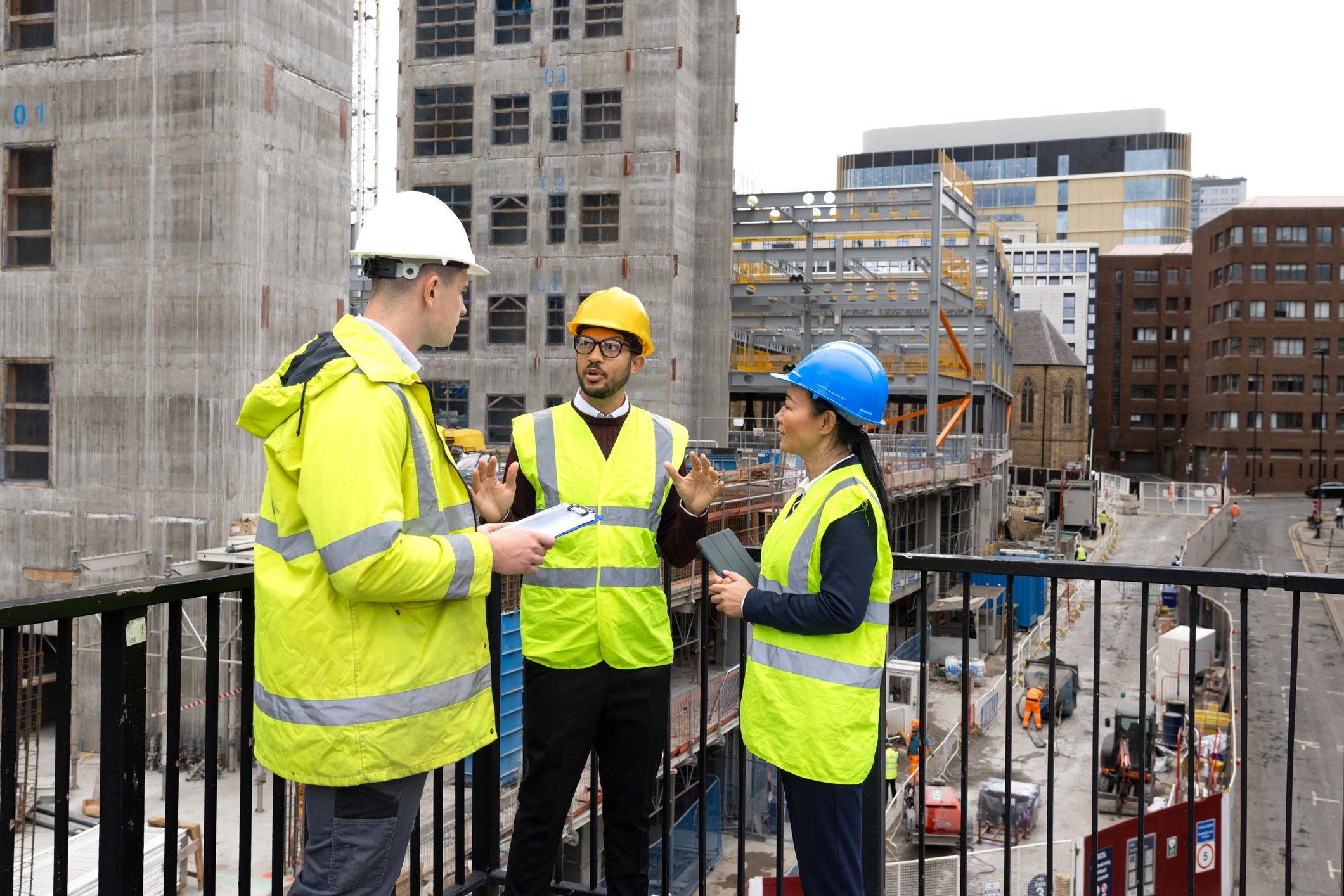 Construction project leaders reviewing plans on site